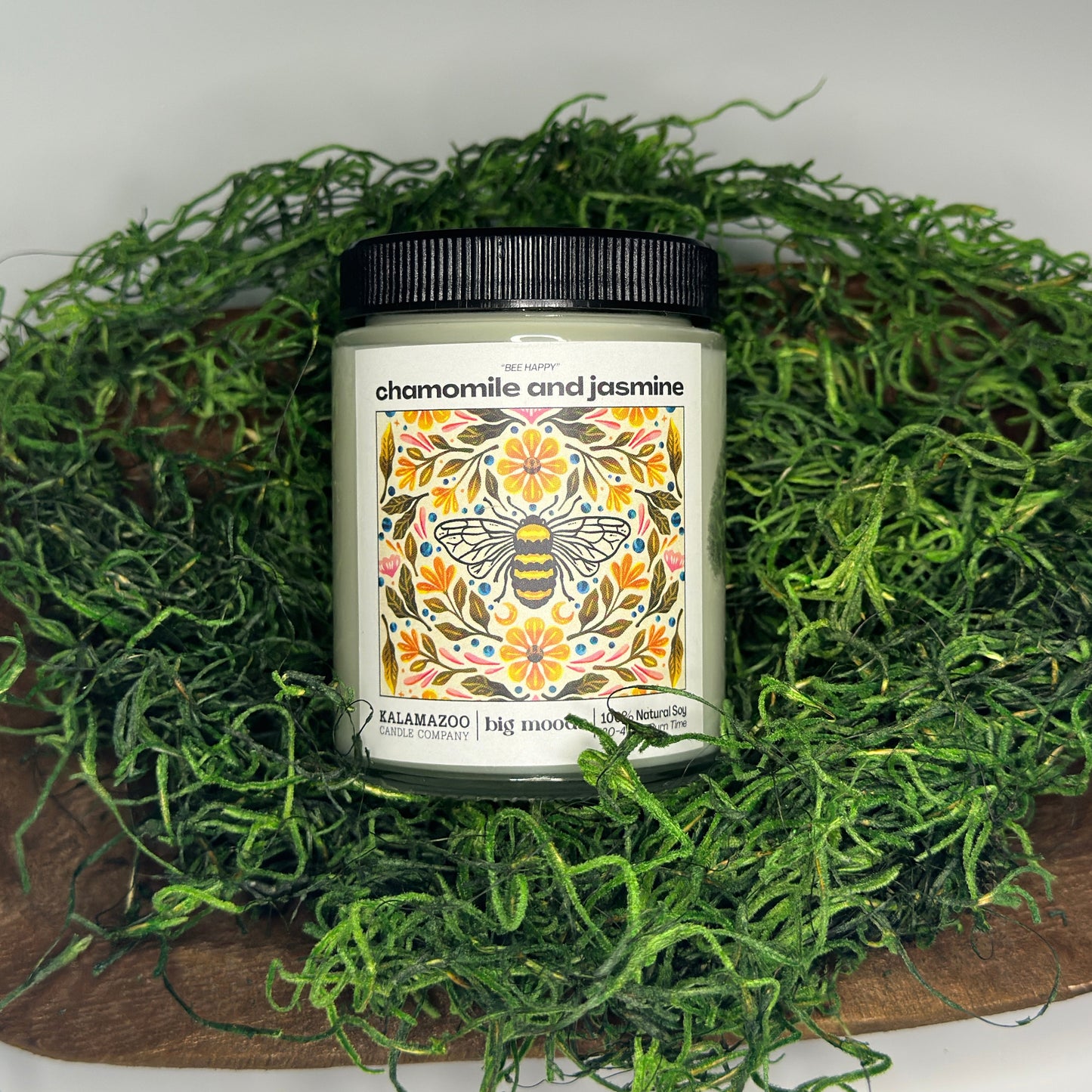 Cosmetic container with decorative label on a bed of green moss