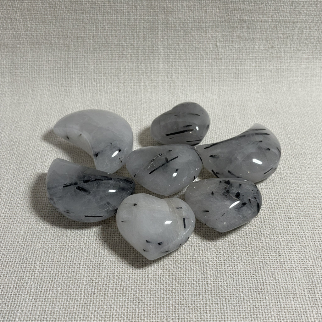 Set of gray stones with black specks on a white background