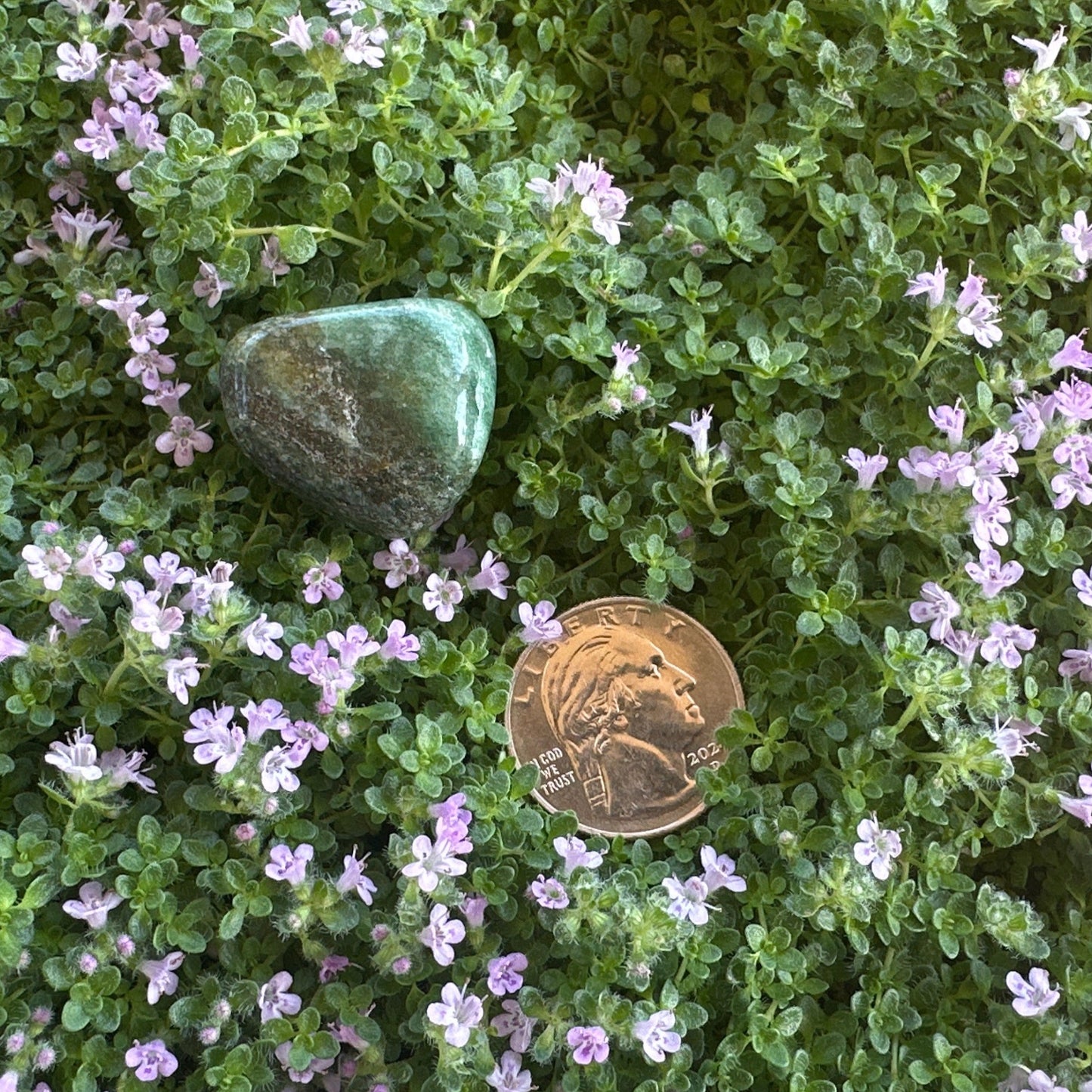 Green aventurine tumbled stone - detailed view showing natural inclusions and polished texture