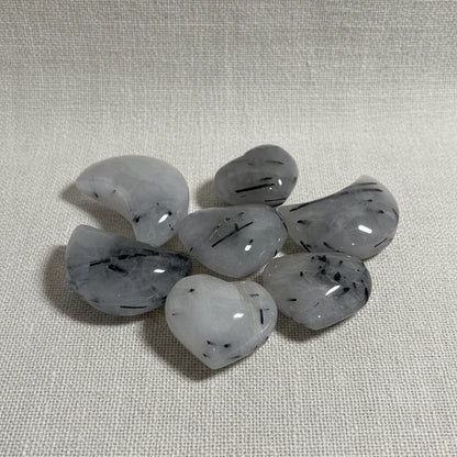 Set of gray stones with black specks on a white background