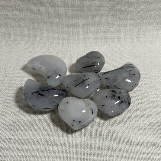 Set of gray stones with black specks on a white background