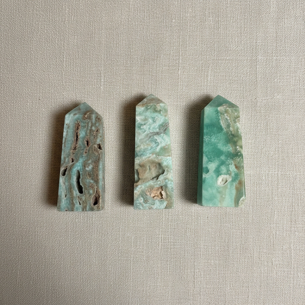 Four green and brown stone slabs on a light gray fabric.