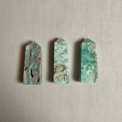 Four green and brown stone slabs on a light gray fabric.