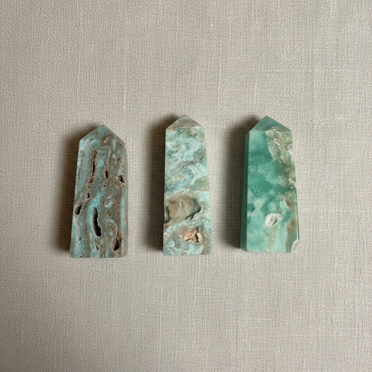 Four green and brown stone slabs on a light gray fabric.