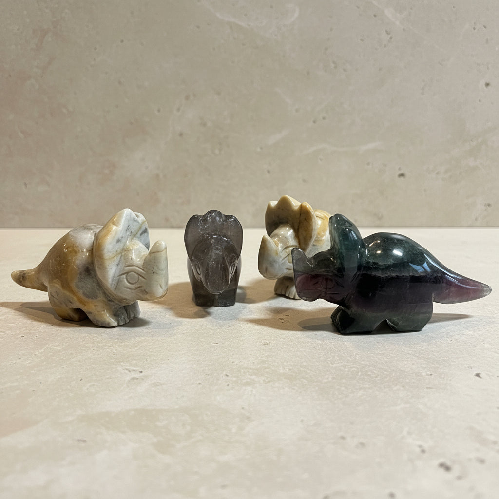 Four stone carvings of animals on a white background