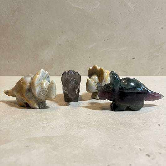 Four stone carvings of animals on a white background