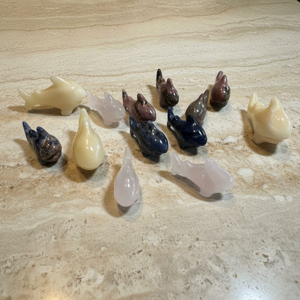 Collection of various stone carvings on a white surface